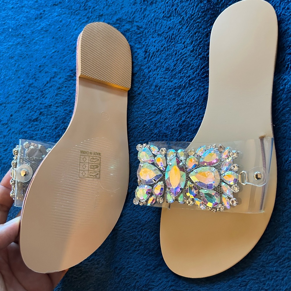 Flip flop sandals adorned with reflective hardware